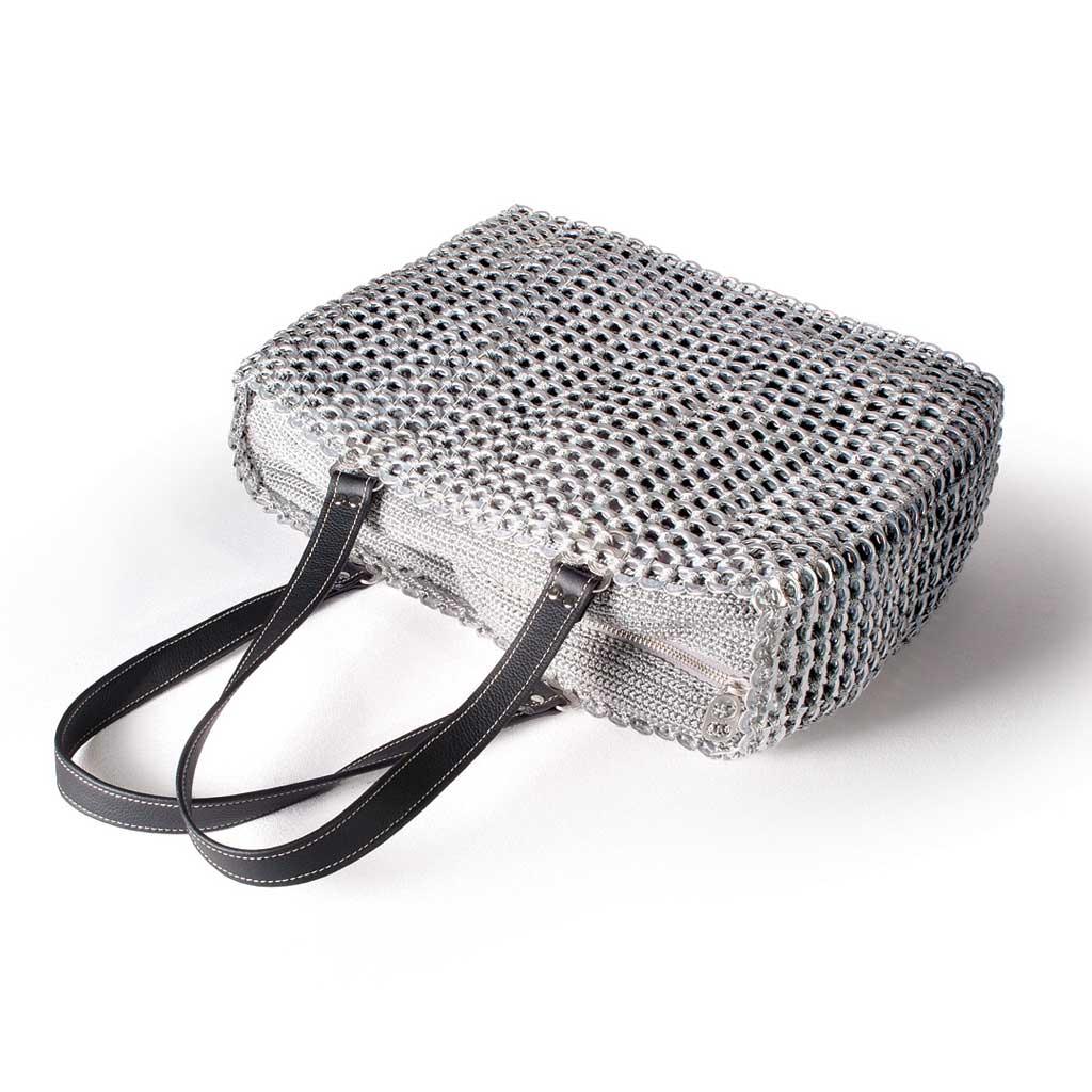 alt="silver metallic woven tote made of recycled materials by Escama Studio"