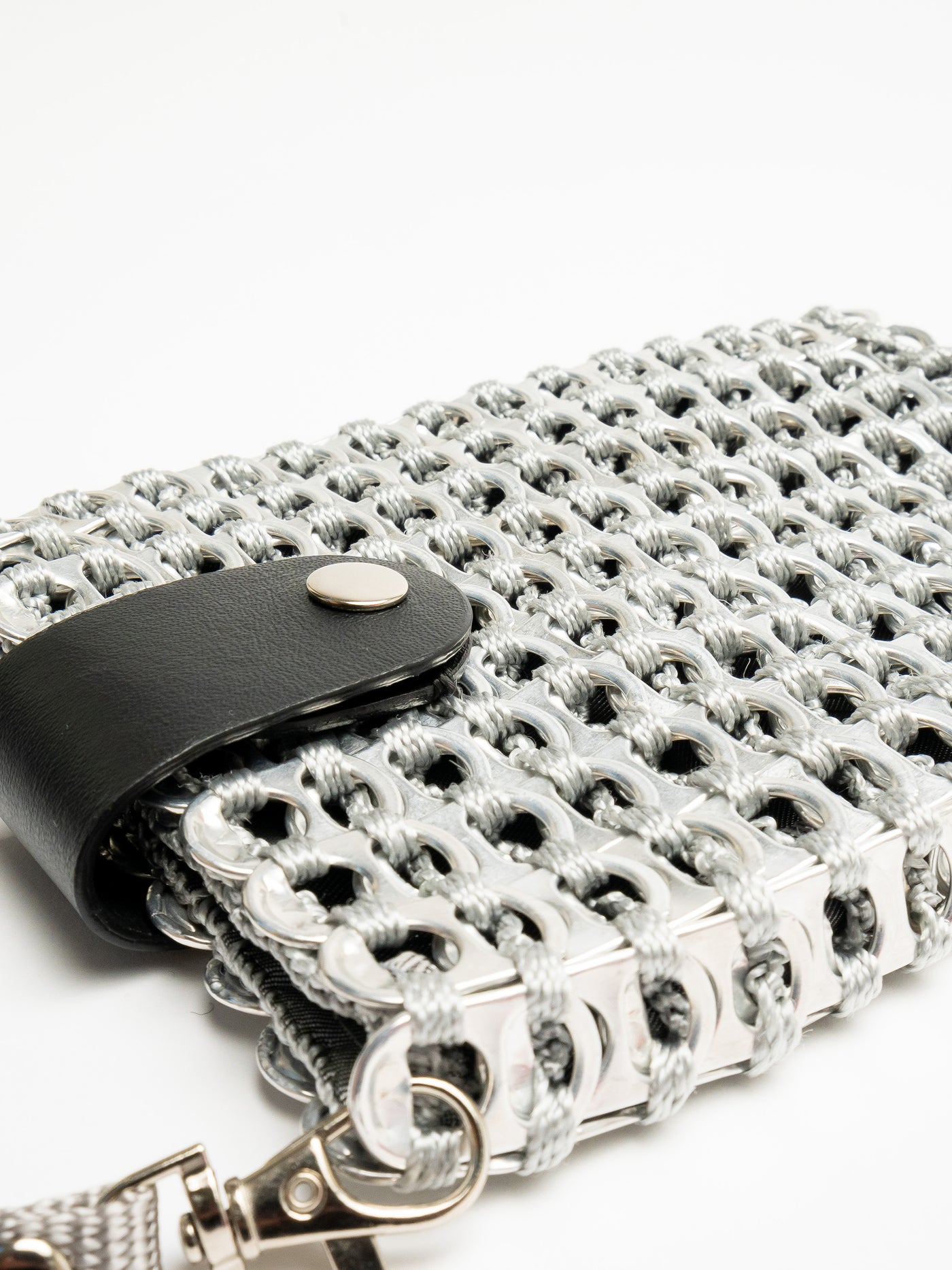 alt="crossbody phone bag made from aluminum tabs with leather fold over snap closure - escama studio"