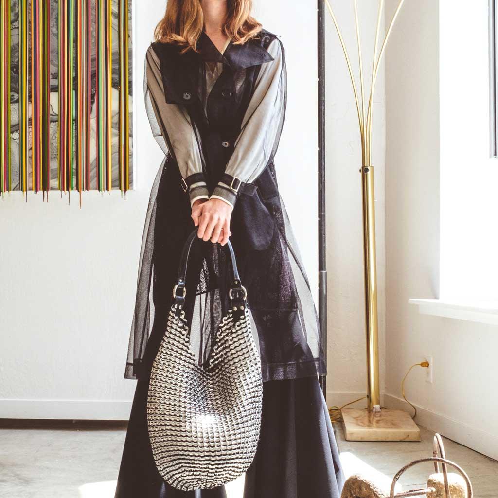 alt="black and silver round woven boho purse made of recycled aluminum pop tabs and a leather strap - escama laura bag"