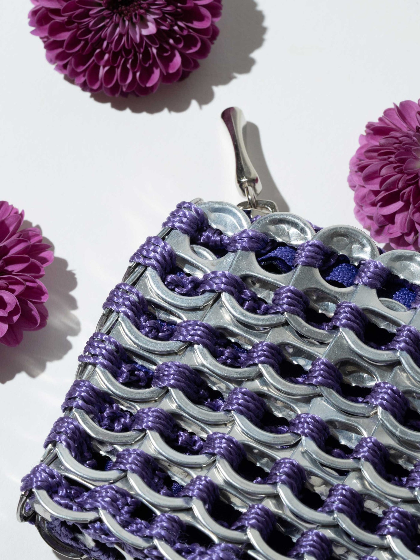 alt="purple flowers with purple coin purse - escama studio"