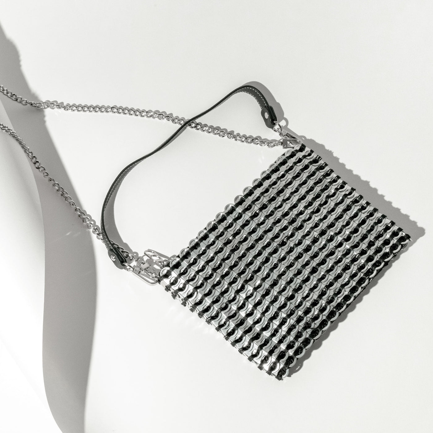 alt="silver clutch made from soda pop tabs - escama studio"